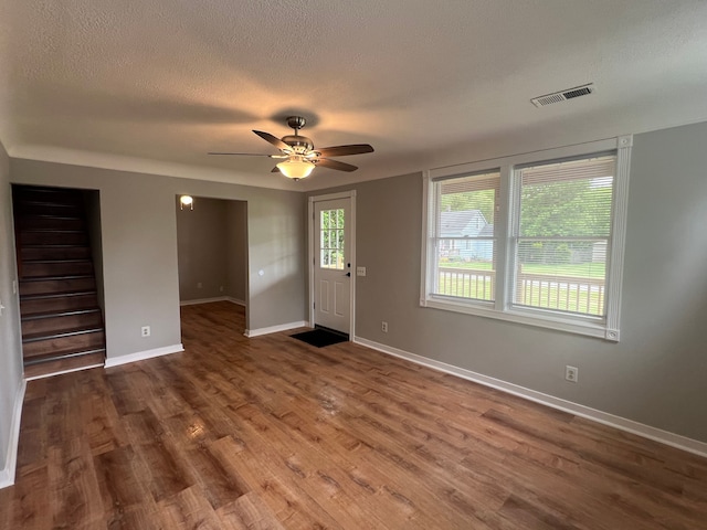 22332 Homestead St, Taylor, MI 48180 - foyer featuring wood finished floors, a textured ceiling, a ceiling fan, and baseboards