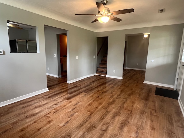 22332 Homestead St, Taylor, MI 48180 - unfurnished room featuring ceiling fan, stairs, wood finished floors, and baseboards