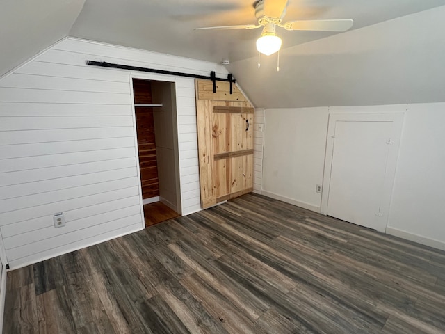 22332 Homestead St, Taylor, MI 48180 - additional living space featuring lofted ceiling, a ceiling fan, dark wood finished floors, wood walls, and baseboards