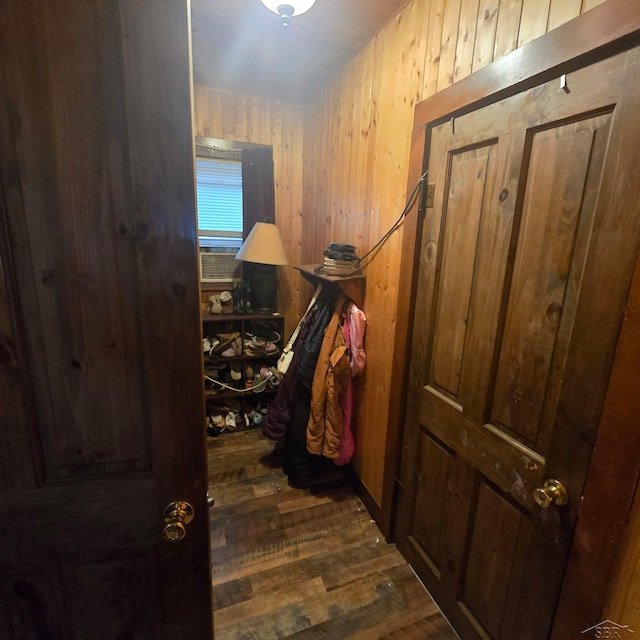 hall featuring hardwood / wood-style floors and wooden walls