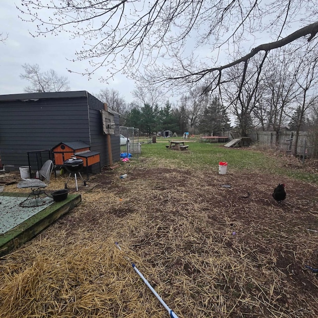 view of yard with fence and an outdoor structure