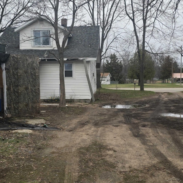 view of side of home featuring a chimney