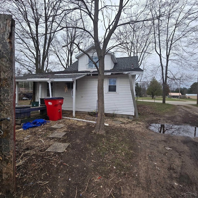 view of side of home featuring a shingled roof