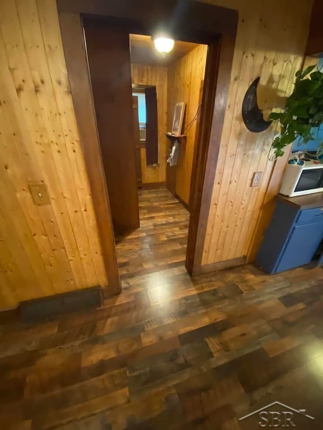 1390 E Wilcox Ave, White Cloud, MI 49349 - hallway with wooden walls and wood finished floors