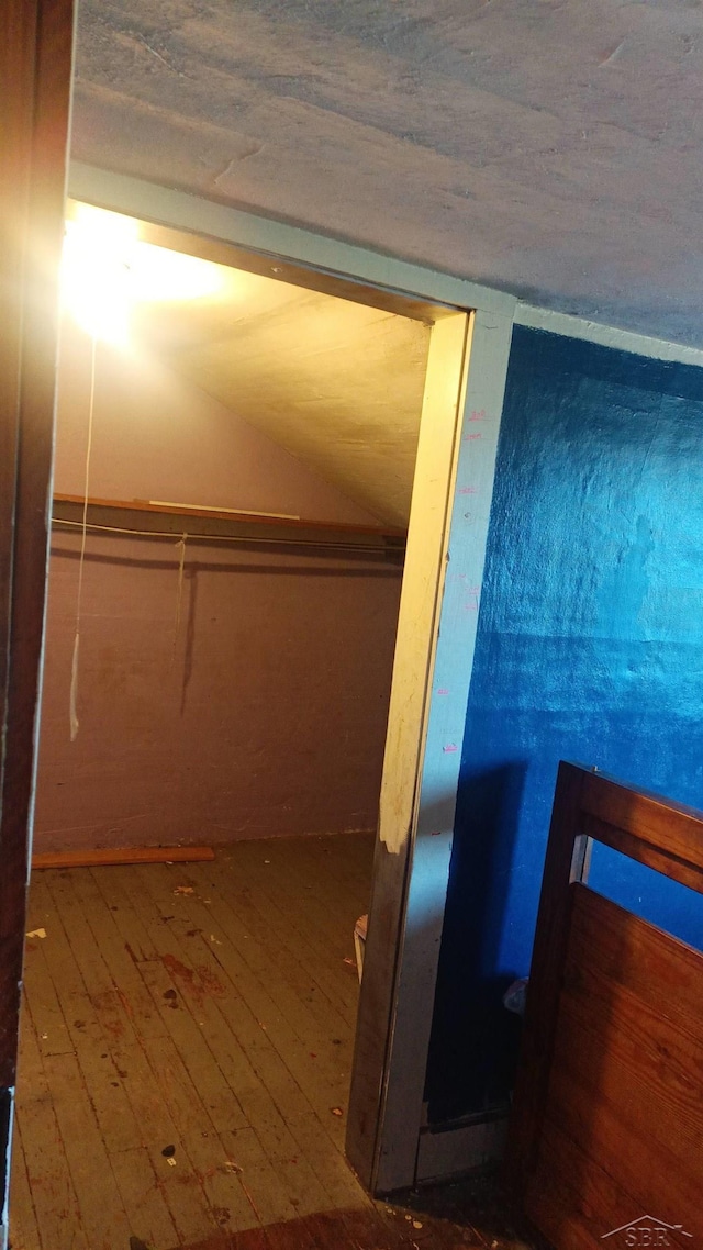 1390 E Wilcox Ave, White Cloud, MI 49349 - interior space with wood-type flooring and lofted ceiling