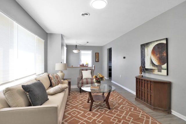 living room featuring wood finished floors and baseboards