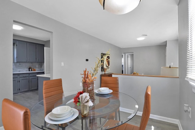 dining space with wood finished floors and baseboards