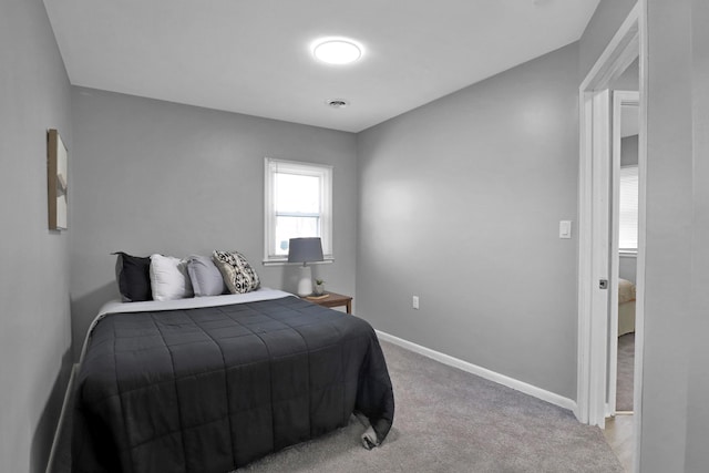bedroom featuring carpet floors and baseboards