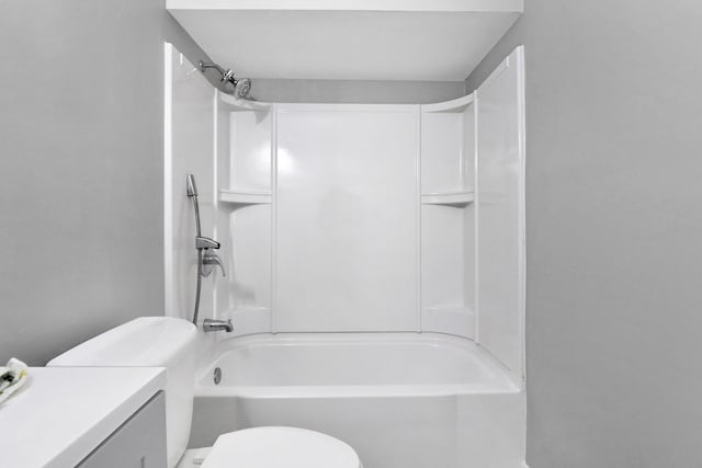 bathroom with toilet, bathing tub / shower combination, and vanity