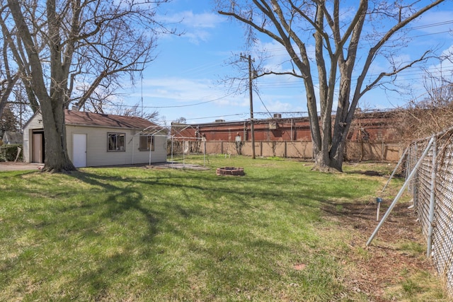view of yard featuring an outdoor fire pit and a detached garage