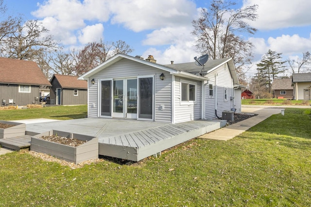 8033 S Portage Rd, Jackson, MI 49201 - back of house with a lawn, a wooden deck, and a fire pit