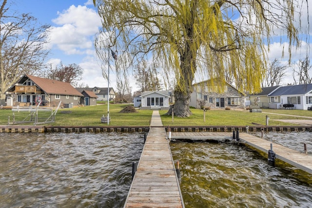 8033 S Portage Rd, Jackson, MI 49201 - view of dock with a yard, a residential view, and a water view