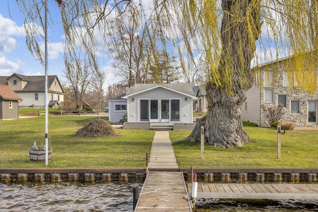 8033 S Portage Rd, Jackson, MI 49201 - rear view of house with stone siding, a water view, and a yard