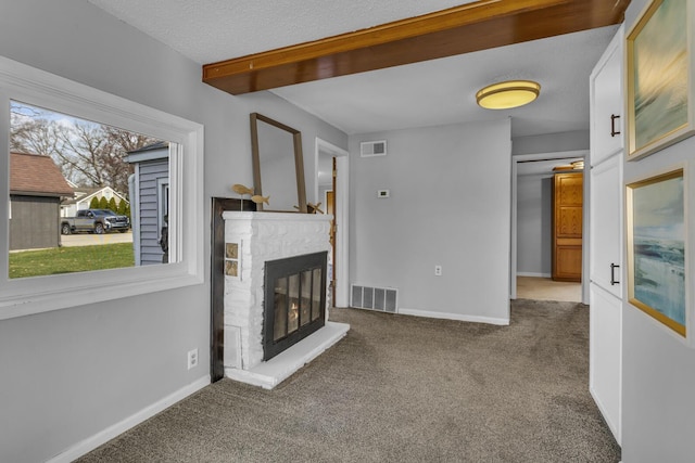 8033 S Portage Rd, Jackson, MI 49201 - unfurnished living room with carpet, baseboards, visible vents, and a fireplace