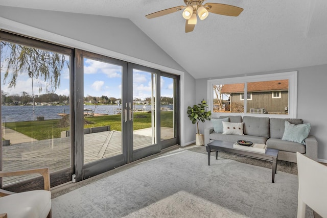 8033 S Portage Rd, Jackson, MI 49201 - living room featuring lofted ceiling, a water view, a ceiling fan, baseboards, and a textured ceiling