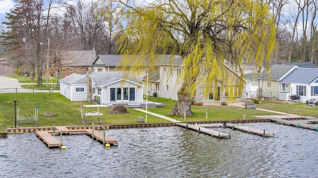 8033 S Portage Rd, Jackson, MI 49201 - dock area with fence, a lawn, a residential view, and a water view