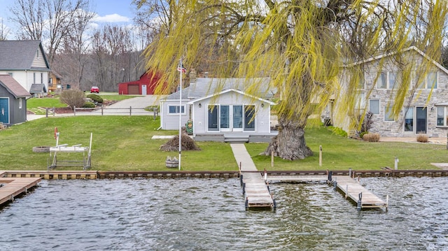 8033 S Portage Rd, Jackson, MI 49201 - view of dock with a lawn and a water view