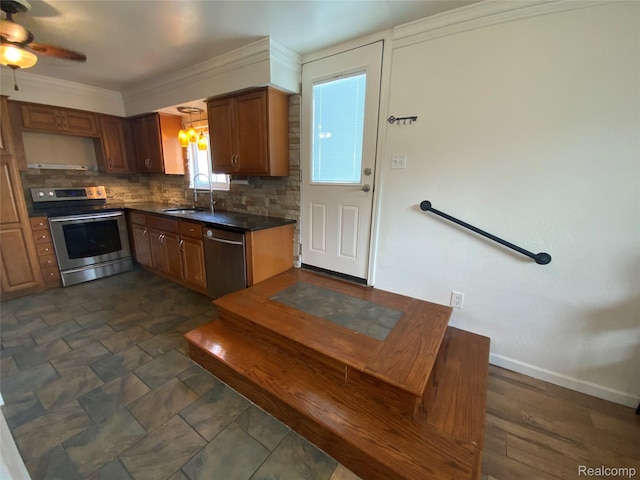 135 Gerald Ave, Clawson, MI 48017 - kitchen featuring appliances with stainless steel finishes, a sink, dark countertops, decorative backsplash, and ceiling fan