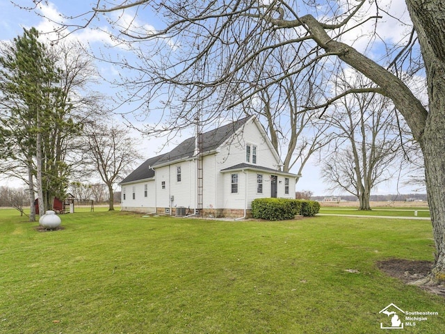 view of property exterior with a yard and central AC
