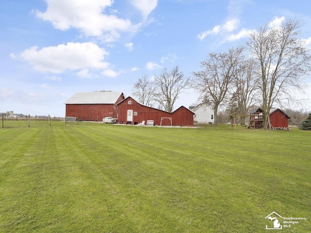 view of yard with an outbuilding and a barn