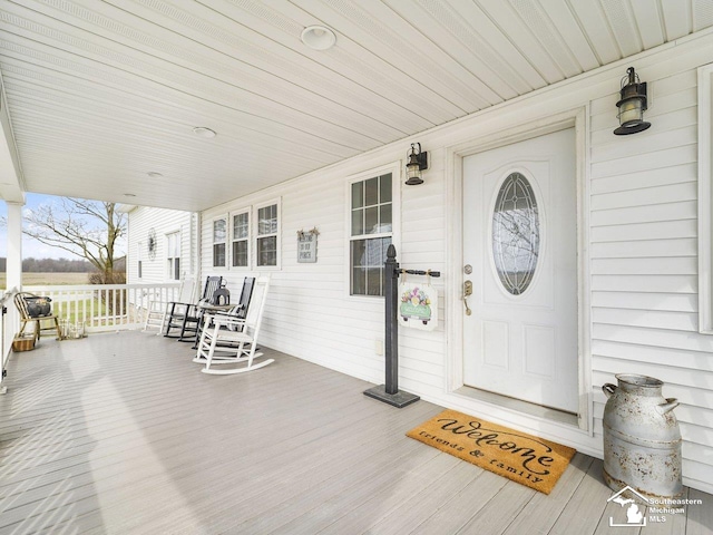 view of exterior entry featuring a porch