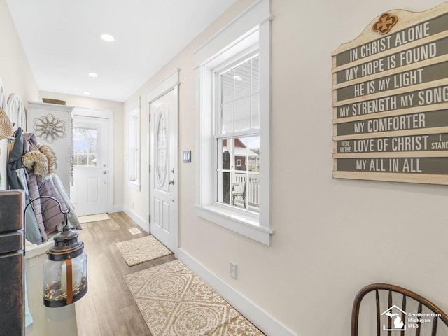 entryway with baseboards, recessed lighting, and wood finished floors