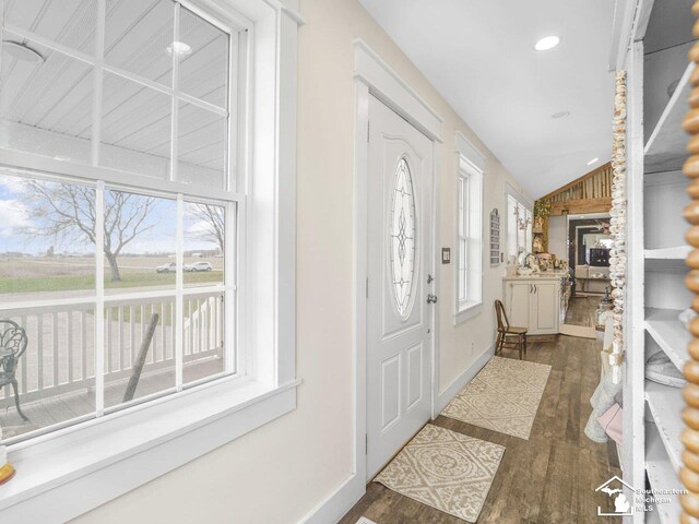 foyer entrance featuring recessed lighting, dark wood-style flooring, lofted ceiling, and baseboards