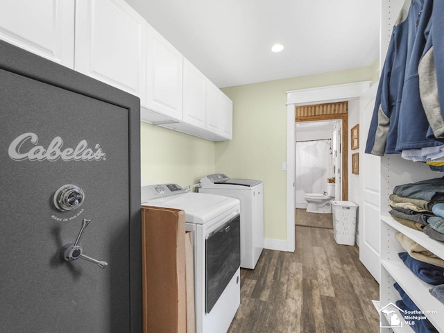 laundry area with recessed lighting, cabinet space, washing machine and dryer, baseboards, and dark wood-type flooring