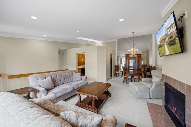 carpeted living area with ornamental molding, recessed lighting, an inviting chandelier, and a tiled fireplace