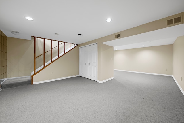 finished basement with visible vents, carpet flooring, and baseboards