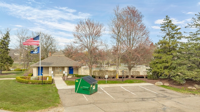 exterior space with a yard and uncovered parking