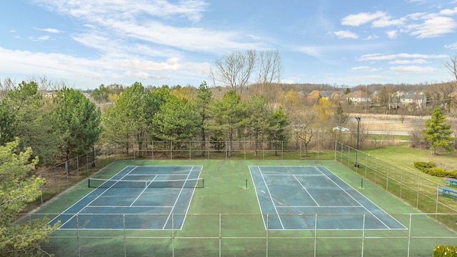 view of tennis court featuring fence