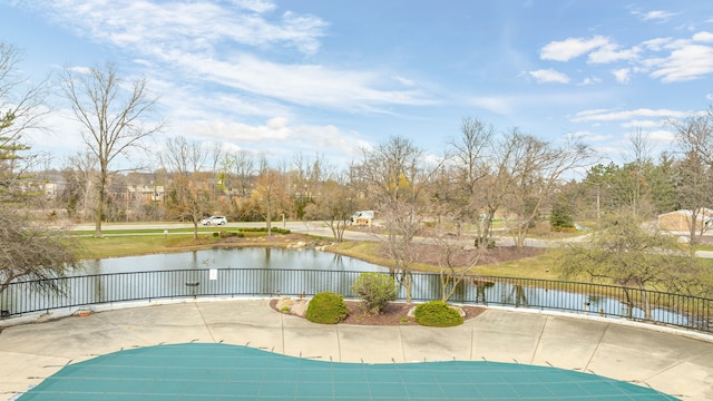 view of pool with a fenced in pool, a patio, a water view, and fence