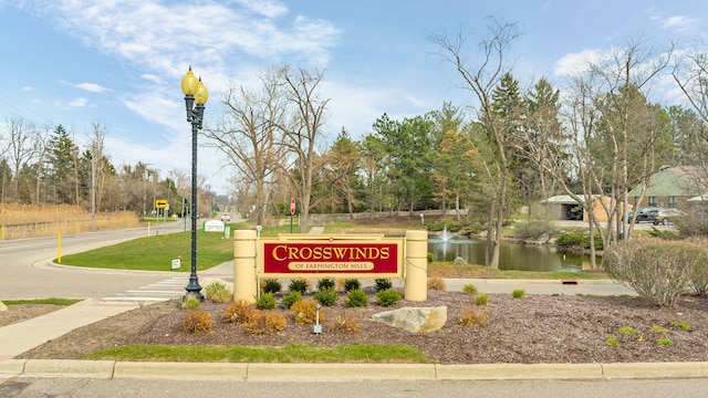 community / neighborhood sign with a water view