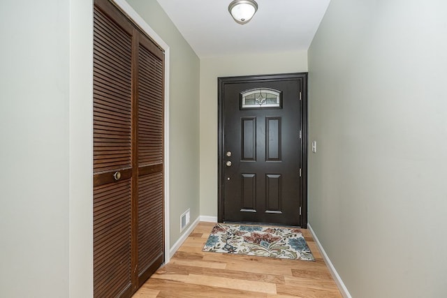 entryway featuring baseboards, light wood-style flooring, and visible vents