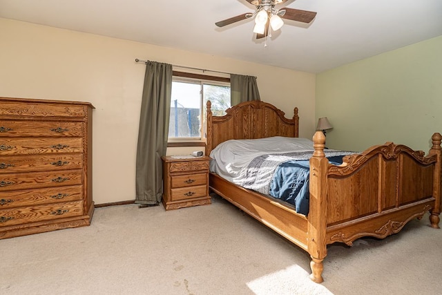 bedroom featuring a ceiling fan, light carpet, and baseboards