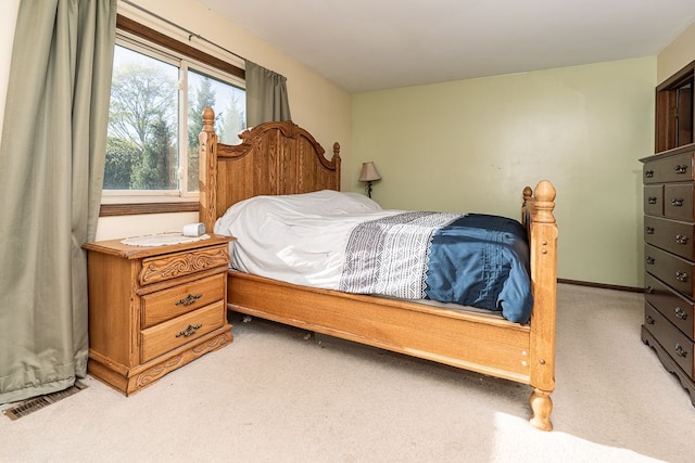 bedroom with light carpet and visible vents