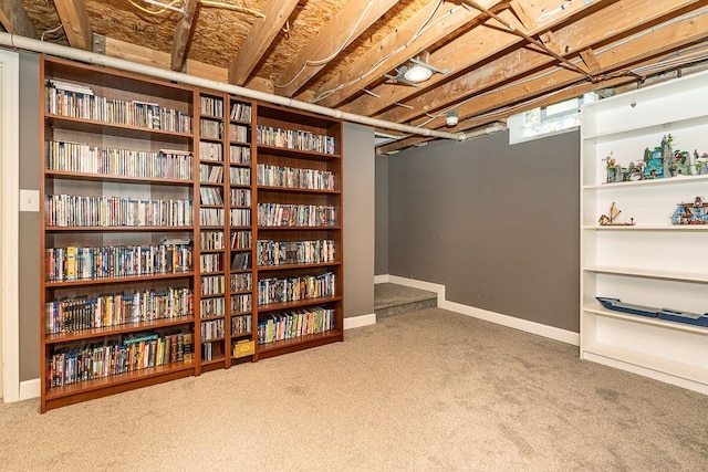 below grade area featuring baseboards and carpet floors