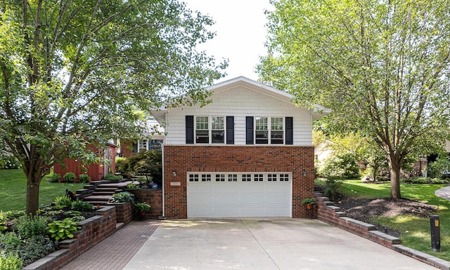 view of front of property with brick siding, an attached garage, a front yard, and concrete driveway