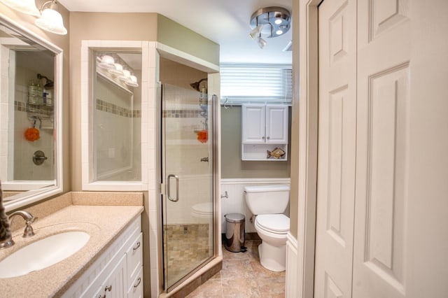 full bath featuring vanity, toilet, and a stall shower
