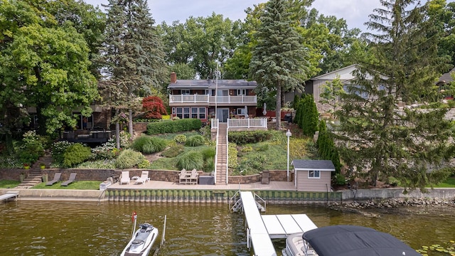 view of dock featuring a deck with water view and stairway
