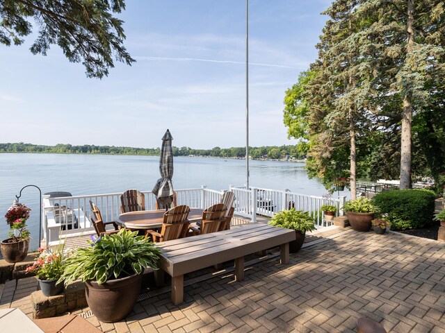 view of patio / terrace with outdoor dining space and a water view