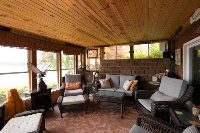 sunroom featuring outdoor lounge area and wooden ceiling