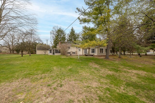 exterior space with a chimney and a yard
