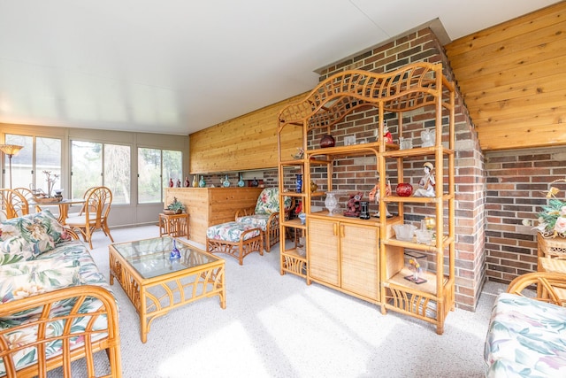 carpeted living area with wood walls
