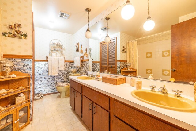 full bath with visible vents, a sink, and wallpapered walls