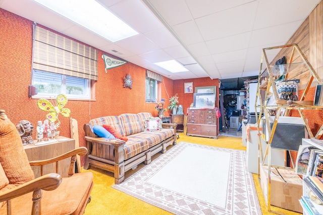 living room featuring a drop ceiling