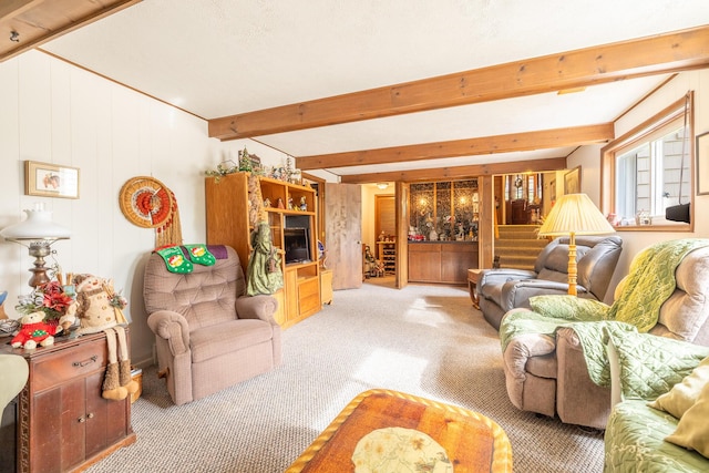 living room with beamed ceiling and carpet floors