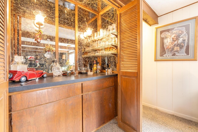 bar with bar area, carpet floors, and a decorative wall