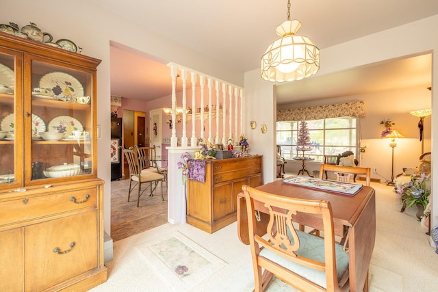 dining area featuring light colored carpet